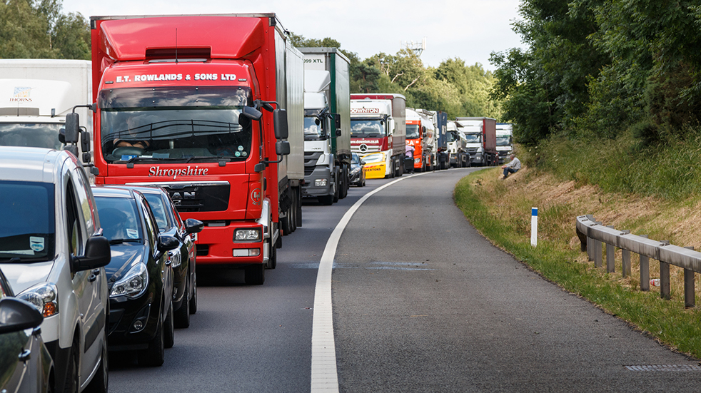 Choose breakdown cover: man on hard shoulder of motorway